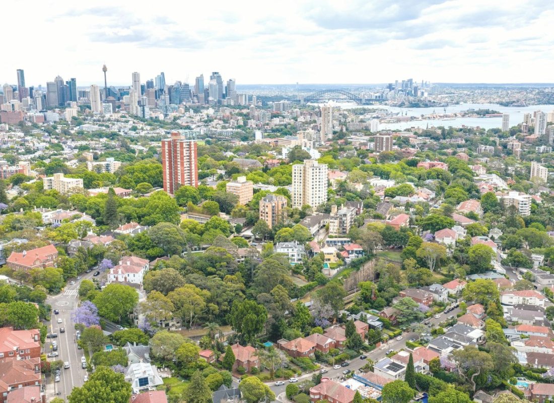 Aerial view of Sydney suburbs with the harbour and city skyline