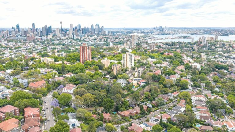 Aerial view of Sydney suburbs with the harbour and city skyline
