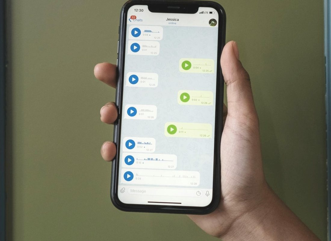 Hand holding a smartphone showing an app screen